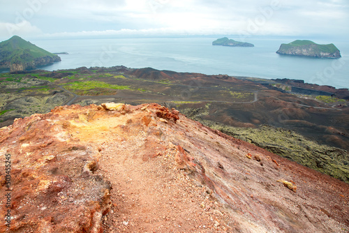 Extinct volcano eldfell on the background of the island Heimaey. Vestmannaeyjar Archipelago. Iceland photo