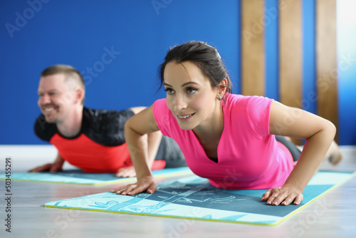 Smiling man and woman doing exercise for fit body goal, active train in morning