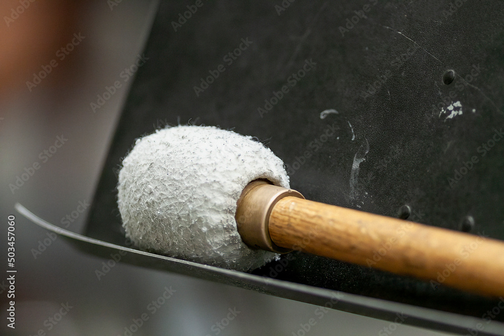 percussion mallet resting on music stand until needed again percussion mallet resting on music stand until needed again