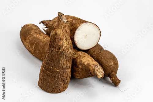 Tapioca / Kappa - roots of the cassava plant, cut and whole isolated in extendable white background shot using studio lights, Isolated, Nobody, Macro, Nutritious, Healthy Food, Roots, tropical food. 