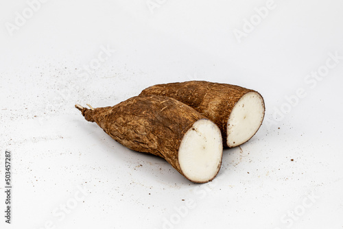 Tapioca / Kappa - roots of the cassava plant, cut and whole isolated in extendable white background shot using studio lights, Isolated, Nobody, Macro, Nutritious, Healthy Food, Roots, tropical food. 
