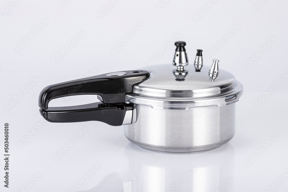 Small Double Valve Pressure Cooker On Neutral Background. Small Double Valve Pressure Cooker On Neutral Background.