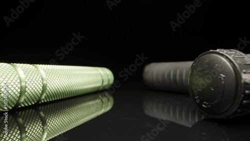 two hand trainers, expanders on a black background. Dolly slider extreme close-up. Laowa Probe photo