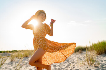 stylish attractive slim smiling woman on beach in summer style fashion trend outfit