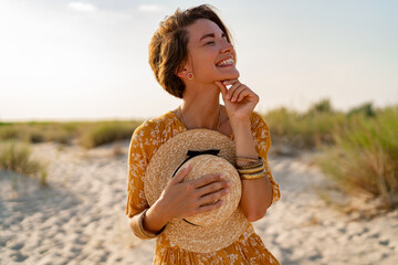 stylish attractive slim smiling woman on beach in summer style fashion trend outfit