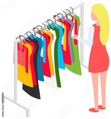 Choosing clothes in store, shopping concept. Female buyer chooses clothing in dressing room. Customer with dress hanging on hanger in mall. Woman shopper stands in fitting room of store or boutique