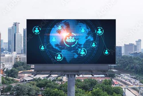 World planet Earth map hologram and social media icons on billboard over panorama city view of Kuala Lumpur, Malaysia, Asia. The concept of people networking and connections.