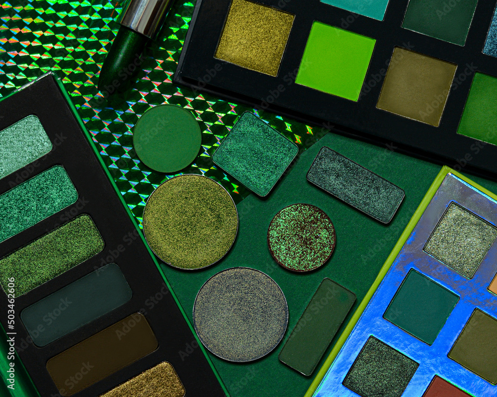 Makeup professional cosmetics in forest green color, decorative and luxury cosmetics on green background. Flat lay image - obrazy, fototapety, plakaty 