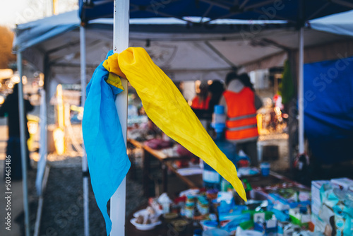 A handkerchief in the colors of the national flag of Ukraine as a symbol of victory is tied to the shelter. Ukrainian refugees head to EU border