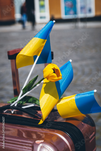 Ukrainian flags and flowers decorated the suitcase with the belongings of Ukrainian refugees.