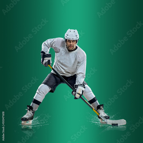 Photography Professional ice hockey player hitting puck for winning goal in action on gradient multicolored neon background
