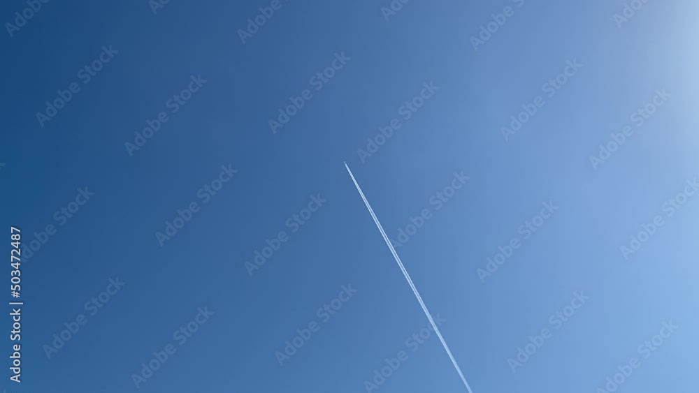 Airplane flying with contrail in the beautiful blue sky Airplane flying with contrail in the beautiful blue sky