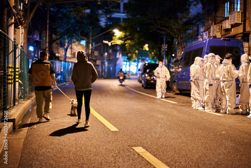 SHANGHAI, CHINA - APRIL 26, 2022: A couple walked their dogs during the lockdown photo