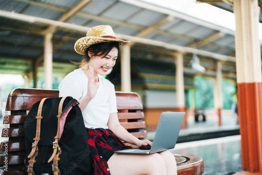 summer, relax, vacation, travel, portrait of beautiful Asian girl using the computer laptop at the train station while waiting for their travel time.