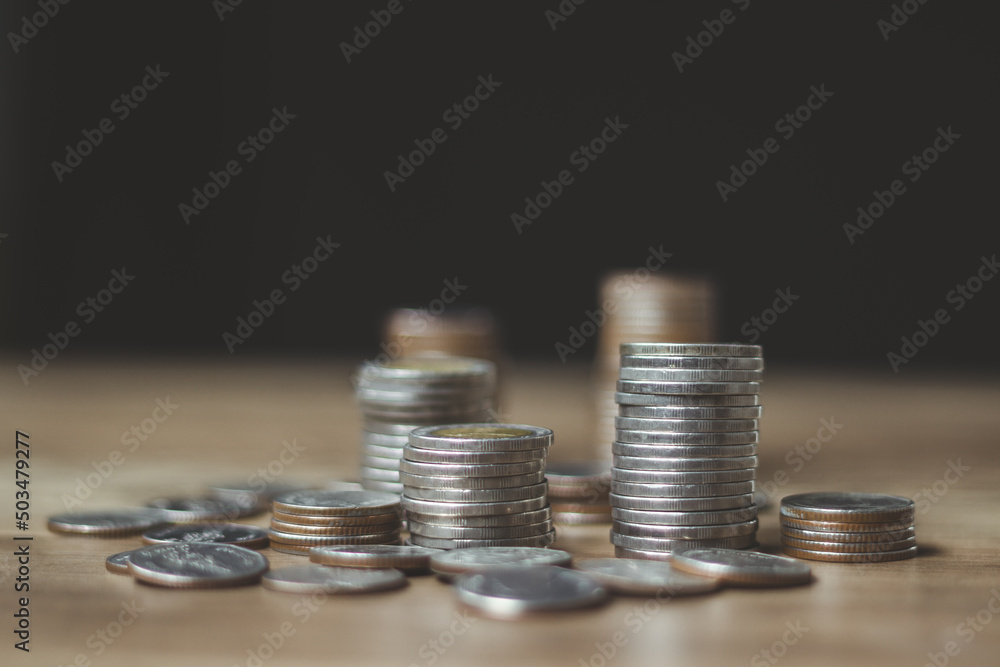 Business Finance and Money Save concept, rows of coins lined up There is a graph showing growth and savings to plan for independent spending.