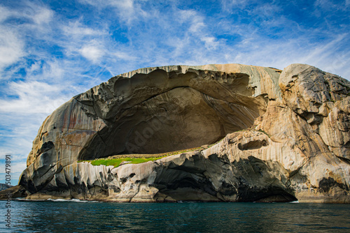 Skull Rock stone island seascape in Cruising tour view in the Bass Strait at Wilson Promontory Victoria Australia, blue sky and blue sea photo
