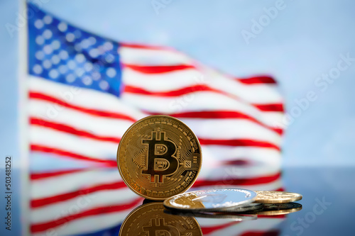 Bitcoin golden coin on American flag. Cryptocurrency with American flag. Beautiful gold bitcoin coin. Cryptocurrency and United States of America concept