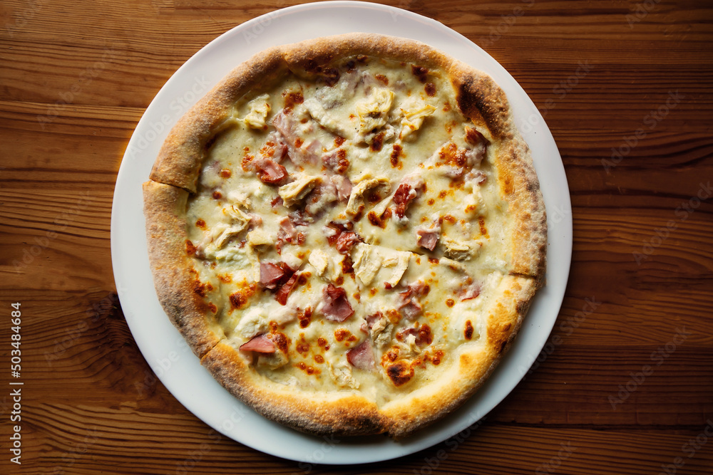 Fresh just made pizza with chiken and ham, spices for pizza in restaurant. Fresh just made pizza with chiken and ham, spices for pizza in restaurant.