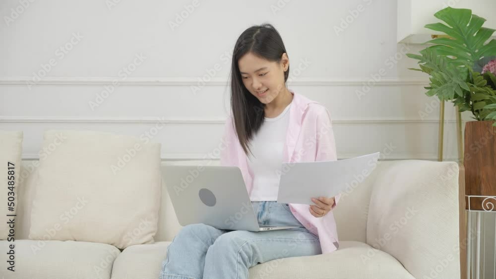 Young asian business woman working on laptop computer and looking graph and chart of report for profit on paper at home, businesswoman looking investment and income, data of infographic statistics. Young asian business woman working on laptop computer and looking graph and chart of report for profit on paper at home, businesswoman looking investment and income, data of infographic statistics.