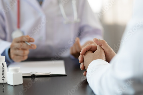 The doctor is conversation to the patient about the illness in the doctor's office and giving advice on health care. Concept of health problem consultation.