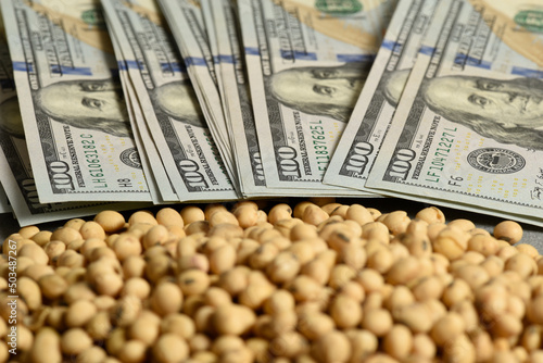 Dollars banknotes and coins and soy beans,oleaginous commoditi value concept. photo