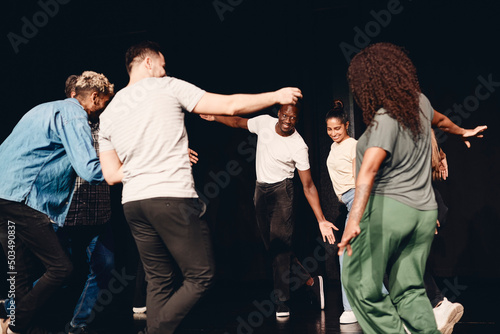 Multiracial male and female stage performers dancing during rehearsal in class