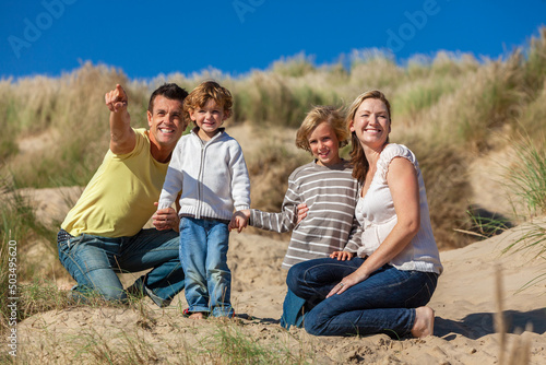 Mother, Father and Two Boys Family Vacation in Sand Dunes on a Beach
