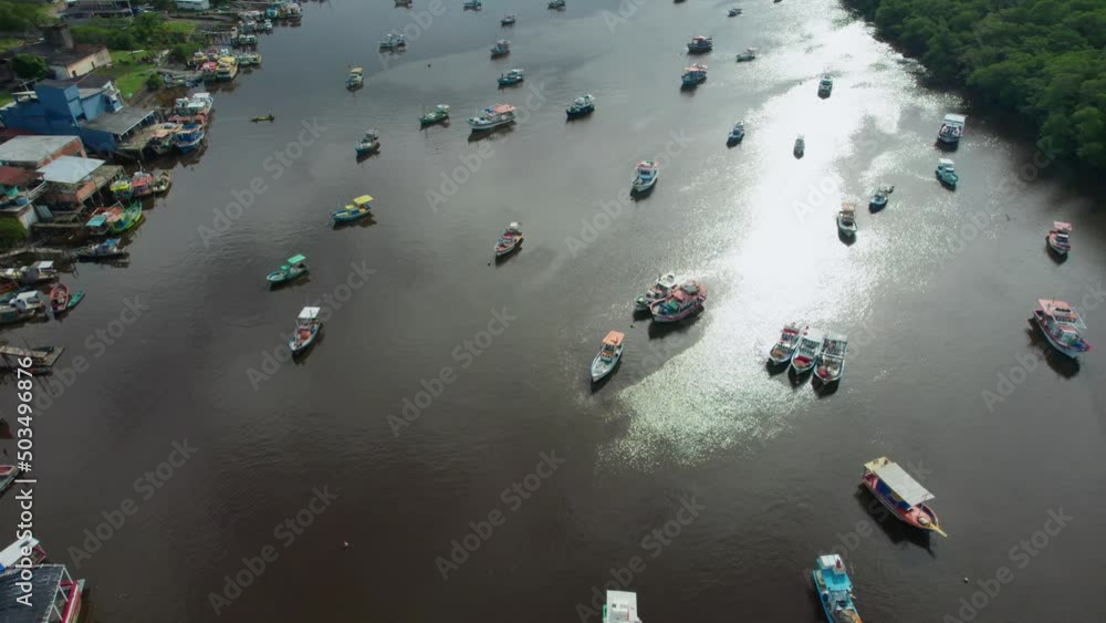 Fishing boats lined up in a river. Nova viçosa, Bahia Brazil. The fishermen are waiting for the tide to change before heading out on the sea. Fishing boats lined up in a river. Nova viçosa, Bahia Brazil. The fishermen are waiting for the tide to change before heading out on the sea.