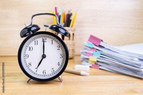 7 AM Clock on work desk in the office Time of business working concepts selective clock