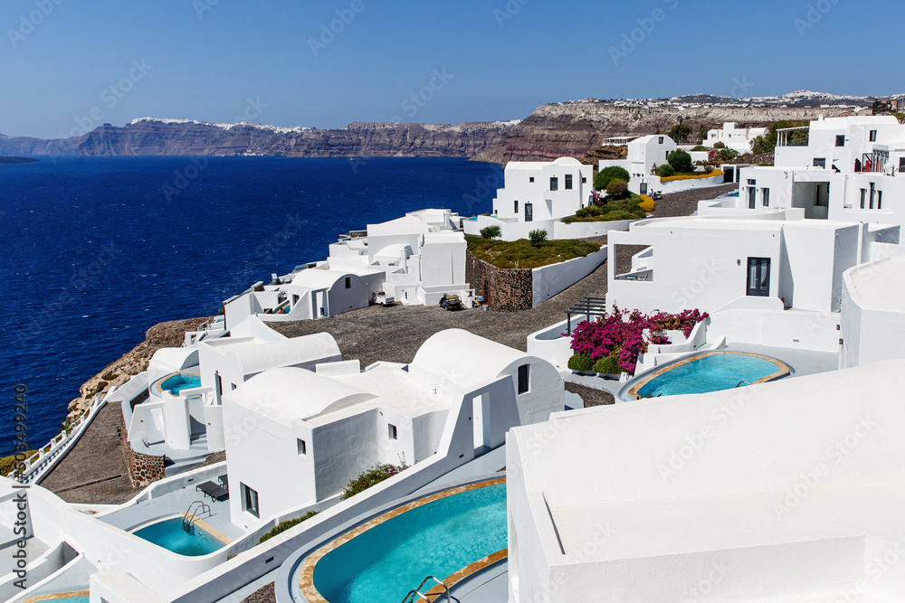Fototapeta premium Greek architecture - small traditional white houses on the coastal cliff