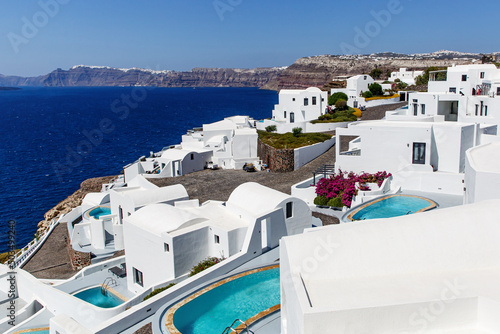 Greek architecture - small traditional white houses on the coastal cliff