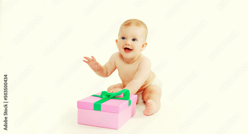 Portrait of happy cheerful laughing baby with gift box sitting on the floor on white background Portrait of happy cheerful laughing baby with gift box sitting on the floor on white background