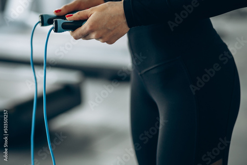 Woman using jumping rope at the gym