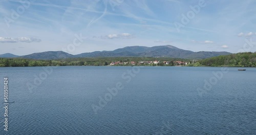 Les eaux calmes du lac et barrage de Michelbach et son village alsacien avec en arriere plan les sommet vosgiens du Rossberg, Waldmatt, Kurrenbourg, Markstein, Croix du Staufen au Grand Ballon  photo