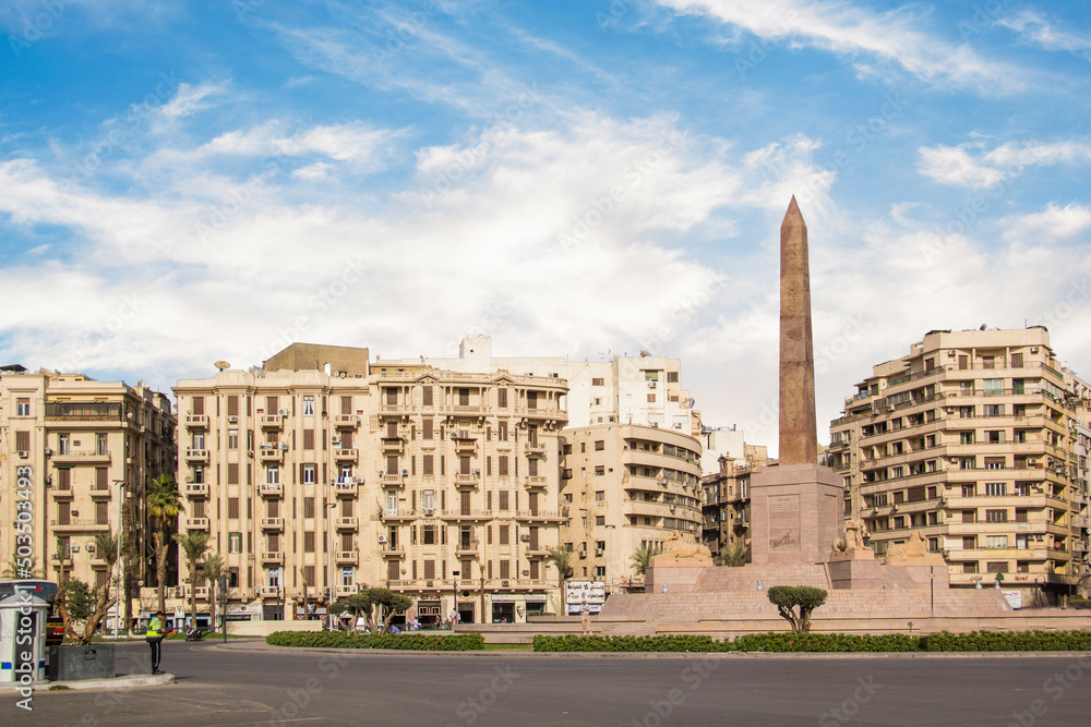 CAIRO, EGYPT - DECEMBER 29, 2021: The Obelisk of Ramses II is surrounded by four ancient sandstone sphinxes in Cairo, Egypt