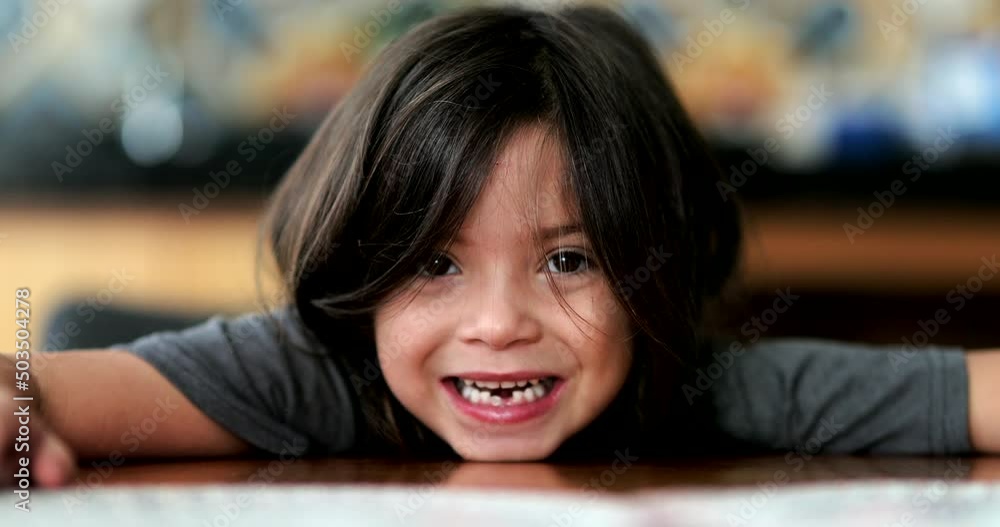 Adorable small girl smiling leaning on table child portrait face Adorable small girl smiling leaning on table child portrait face
