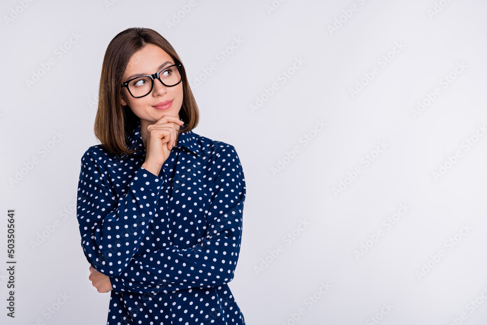 Photo of young charming lady hand touch chin look empty space guess interested wonder isolated over grey color background - obrazy, fototapety, plakaty 