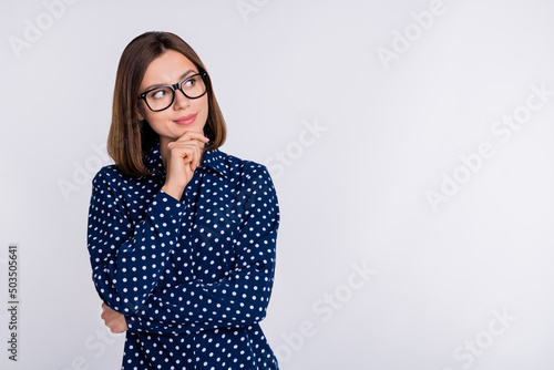 canvas print motiv - deagreez : Photo of young charming lady hand touch chin look empty space guess interested wonder isolated over grey color background