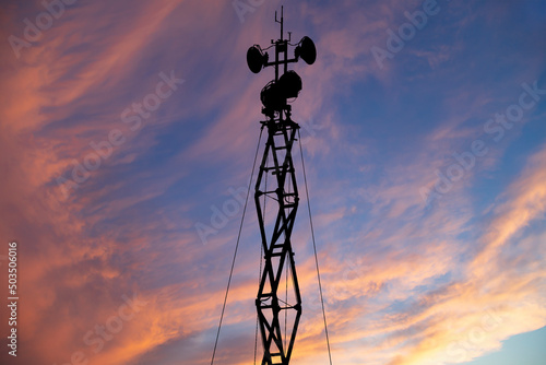 Contour small military radar station on the background of the sunset orange sky. Mobile relay station, Russia photo