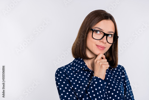 Photo of young pretty lady hand touch chin minded dream wonder look empty space isolated over grey color background