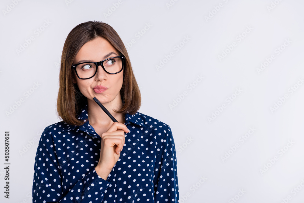 Portrait of attractive minded suspicious girl making decision copy blank space ad isolated over grey pastel color background