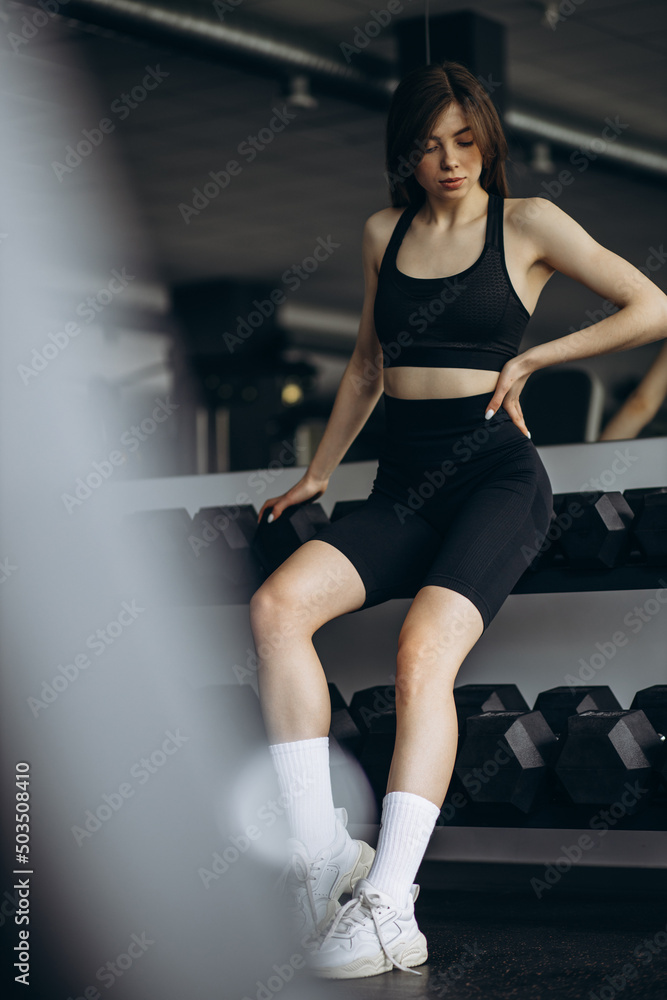 Young woman sitting at the gym Young woman sitting at the gym