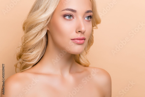Cropped view portrait of attractive perfect wavy-haired girl flawless makeover isolated over beige pastel color background