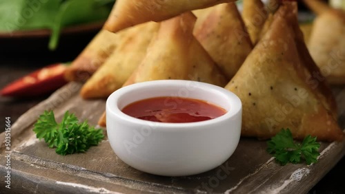 Fried samosas with vegetable filling, popular Indian snacks. dipping in sauce