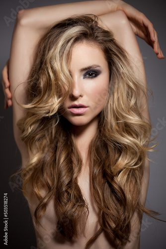 Obraz na plátně Sexy Blond Fashion Model Posing with Perfect Long Hair Looking at Camera in Stud