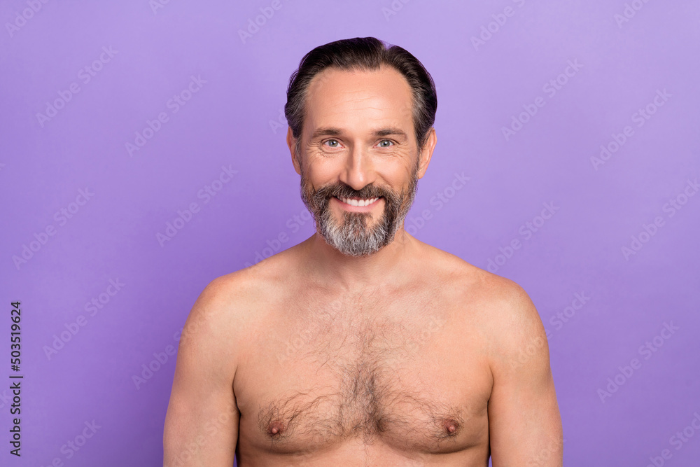 Portrait of handsome masculine mature middle aged male take shower moisturize shoulders isolated on purple color background Portrait of handsome masculine mature middle aged male take shower moisturize shoulders isolated on purple color background