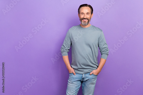 Photo of handsome attractive cool confident business male posing on camera isolated on violet color background