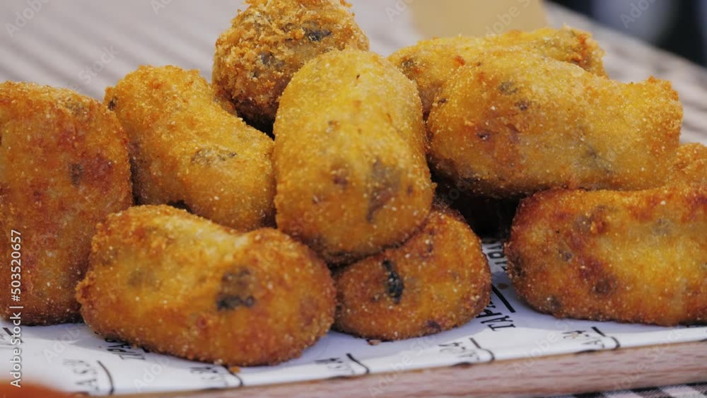 Homemade traditional Spanish croquettes or croquetas on street food festival. Tapas food. Homemade traditional Spanish croquettes or croquetas on street food festival. Tapas food.