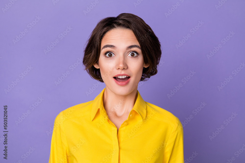 Photo of hooray young lady look camera wear yellow shirt isolated on violet color background Photo of hooray young lady look camera wear yellow shirt isolated on violet color background
