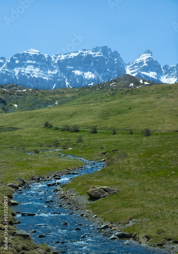 Escarra river with snowy mountains in the background, Huesca Pyrenees.